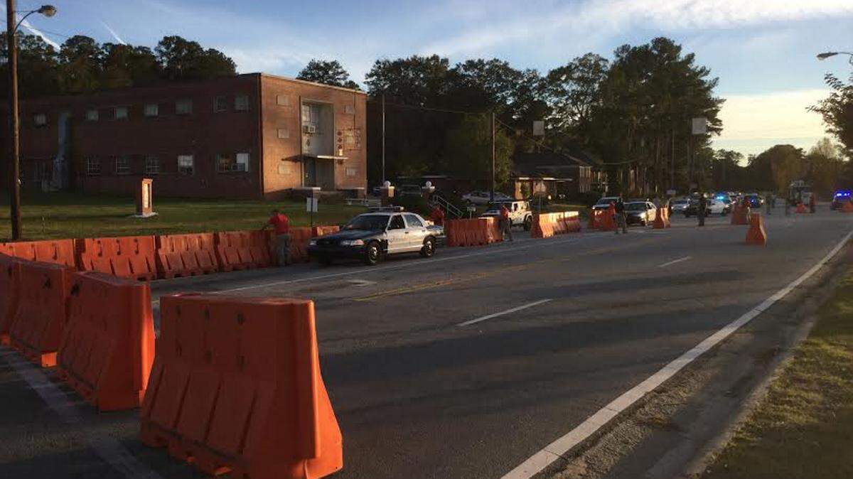 BEN WRIGHT/benw@ledger-enquirer.comPolice place barricades across Benning Road on Friday as part of the preparations for the School of the Americas Watch protest.