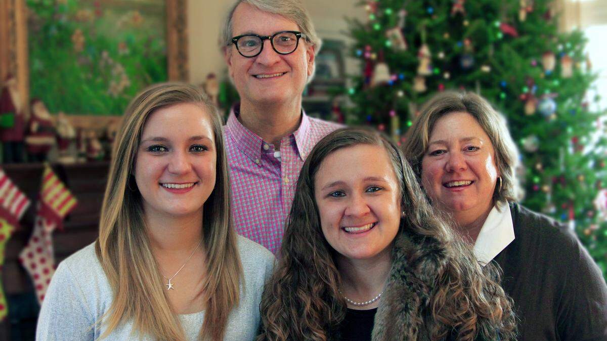 Mike Haskey/mhaskey@ledger-enquirer.comPatrick and Susan Graham, and their daughters, Mary Frances, left, and Katie Claire, pose for a photograph in the family's Columbus home.