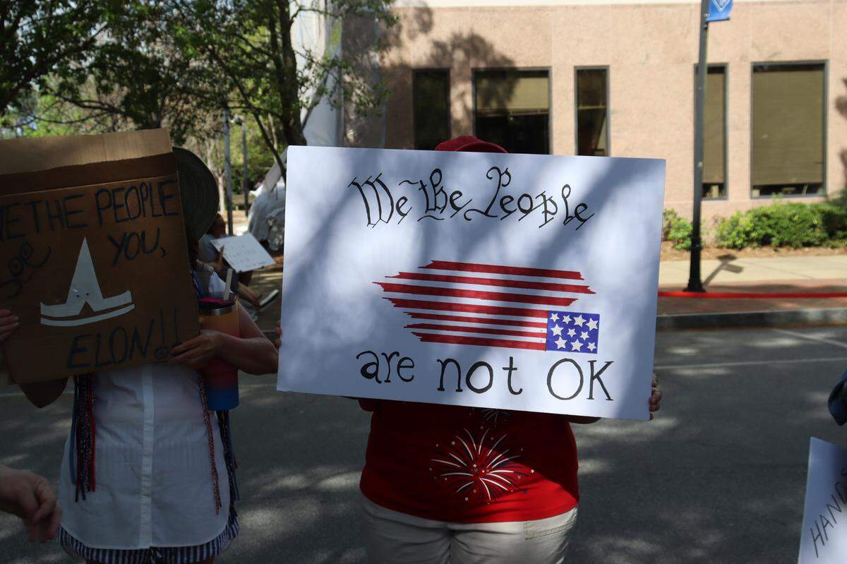 Protesters holding signs at the Hands Off protest in Columbus, 4/5/25 at 1000 Broadway Ave.