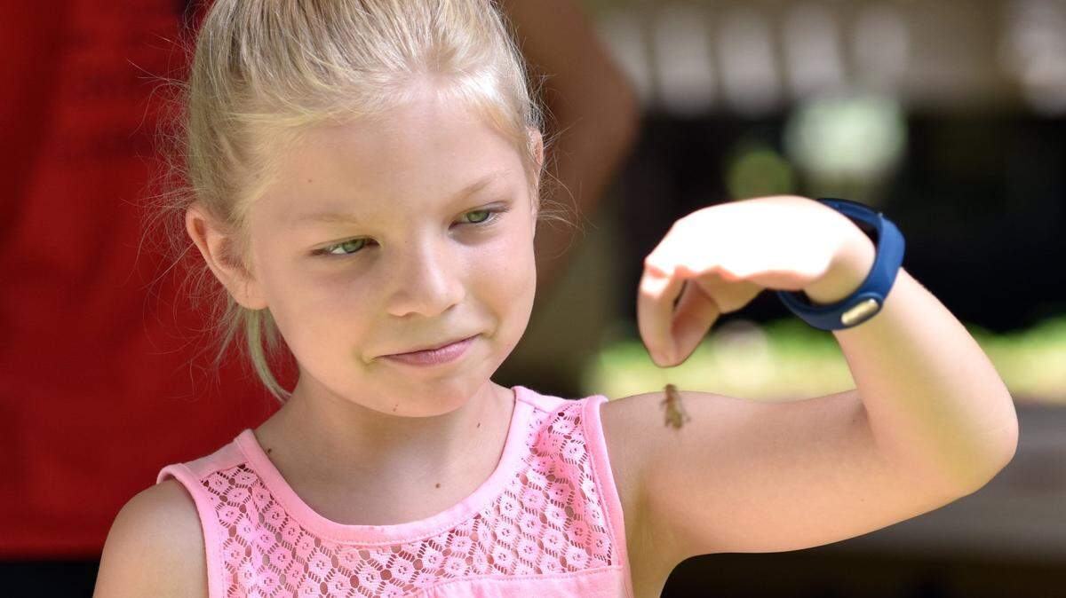 Emma Adams deciding not to trying Cricket spitting during the during the CSU's Oxbow Meadows Environmental Learning Center 17th annual Insectival themed "The Honey Harvest" July 15, 2017