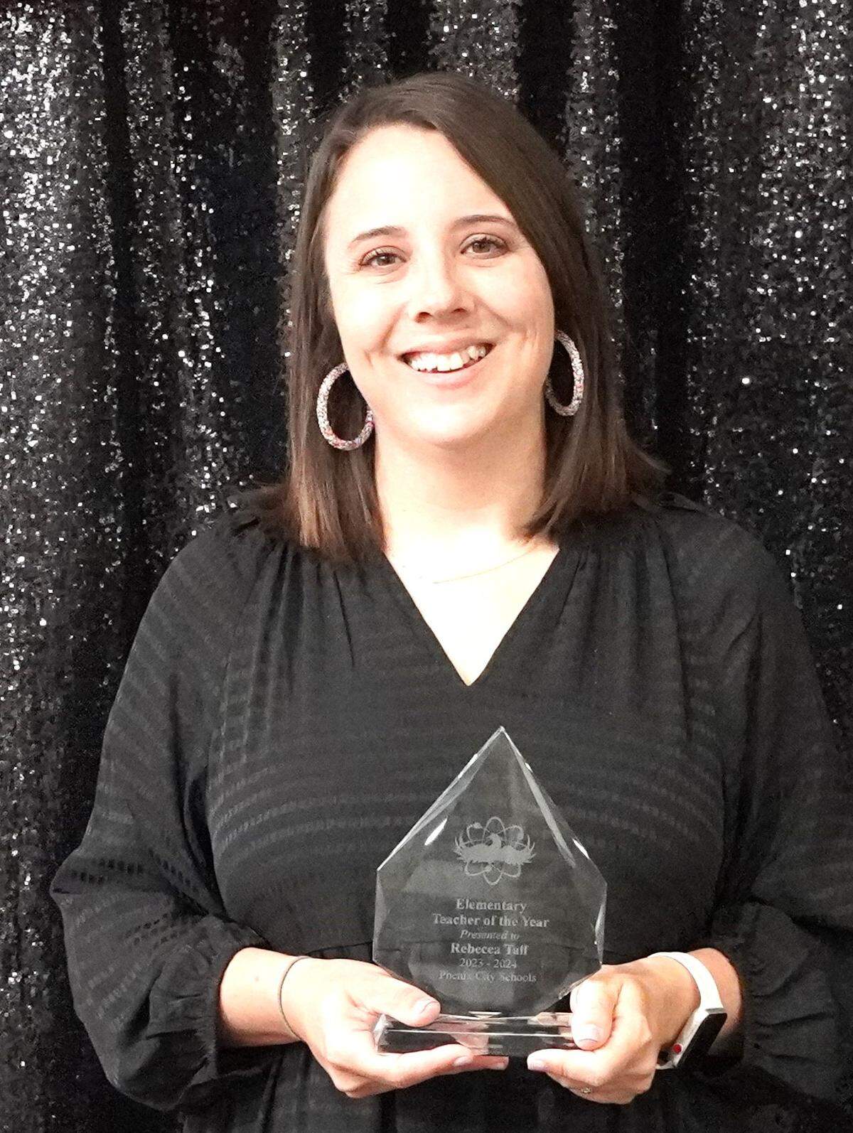 Rebecca Taff, a third-grade teacher at Lakewood, is the Phenix City Schools Elementary Teacher of the Year. She poses with her award at the PCS Night of Stars gala Dec. 7, 2023.