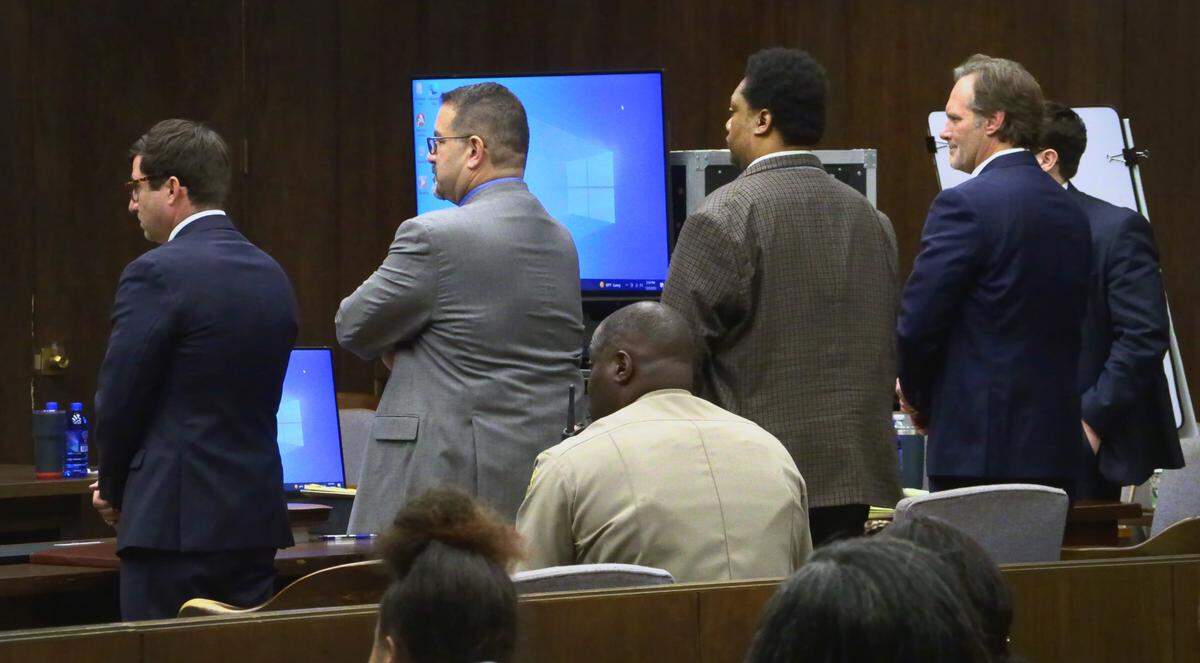 Antonio Bernard “Tony” Willis, standing ,third from left, and his defense attorneys stand as jurors return to the courtroom after a break Thursday afternoon. Willis faces two counts of murder and one count each of aggravated assault and attempting to commit a felony. 12/08/2022