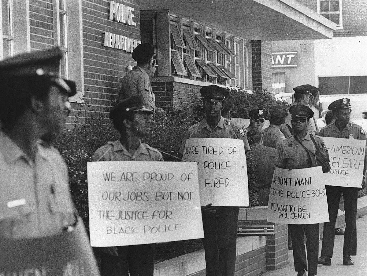 Columbus Police Department officers who were members of the Afro-American Police League protest in front of the police department.