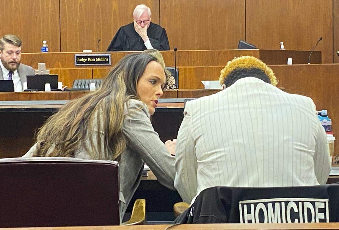 McKenzie Gray, a state attorney general gang prosecutor, speaks to police Sgt. Donna Baker as they prepare for a gang-related murder trial in Columbus.