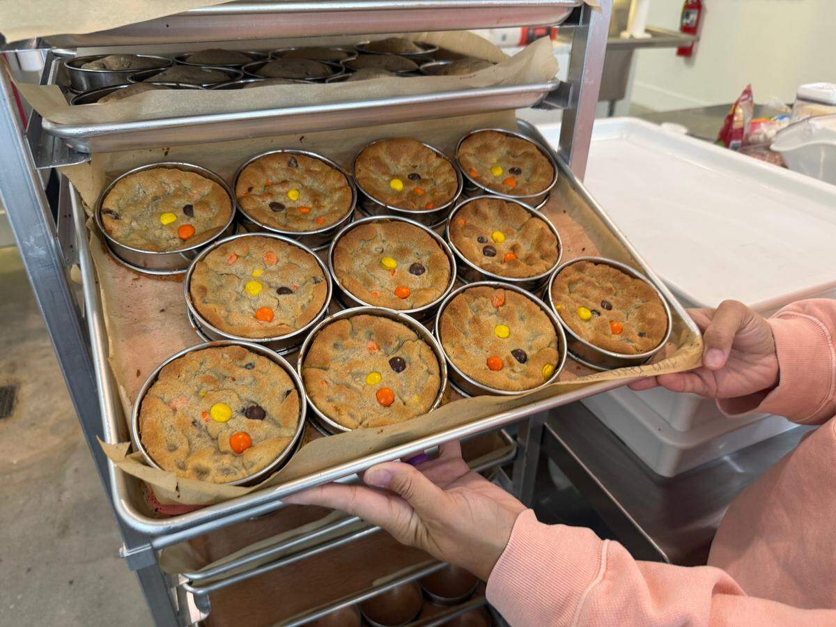 Laura Parsons, owner of The Cookie Co., 3540 Massee Lane in Columbus, shows the Ledger-Enquirer the process of baking their viral flavors. Pictured is the peanut butter chip cookie on June 9, 2025.