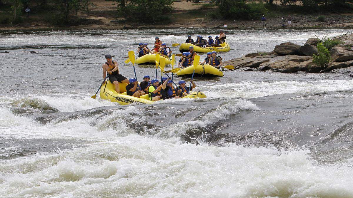 ROBIN TRIMARCHI/rtrimarchi@ledger-enquirer.comIn this May 30, 2013, photo, whitewater rafters play in the Georgia rapids, with the exit from Cut Bait in the background.