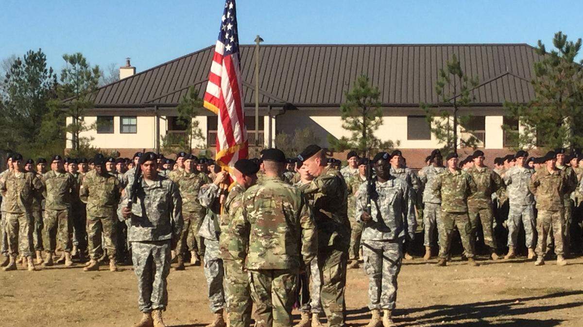 Photos by BEN WRIGHT/bwright@ledger-enquirer.comLt. Col. Fred Tanner, at right, takes the colors from Command Sgt. Maj. Raymond M. Mabrey, at left, as his last official duty with 1st Battalion, 15th Infantry Regiment Tuesday during an inactivation ceremony at Fort Benning.