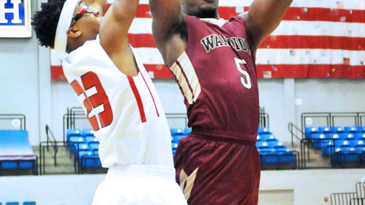 Russell's Damon Lloyd hits the basket against Marion's Kwentez Thomas in the first period of the Shaw Christmas Tournament Boys Group B Championship game Wednesday December 23, 2015
