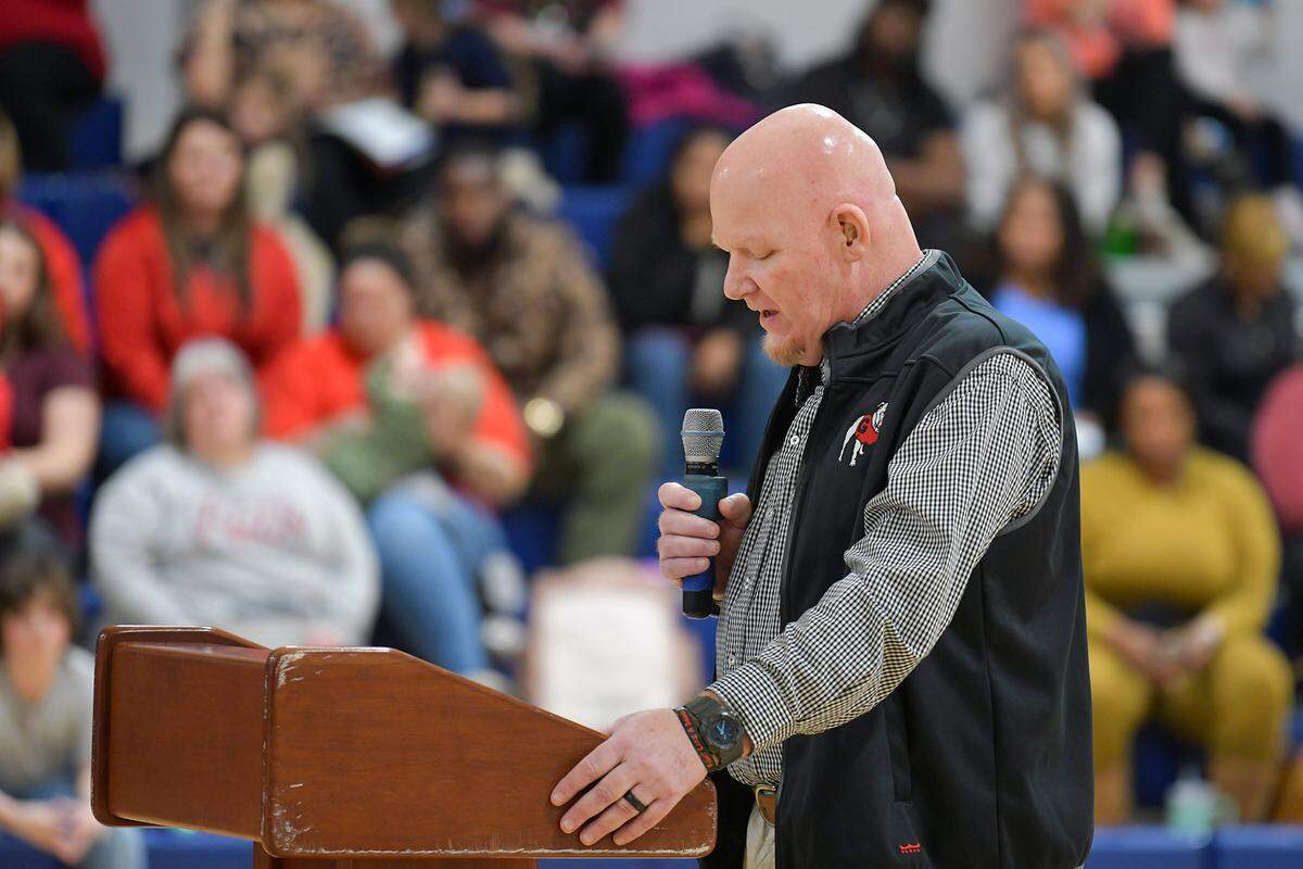 Coach Jay Wilson of Veterans Memorial Middle School in Columbus, Georgia greets guests, family and dignitaries for the dedication ceremony naming school gymnasium’s court in his honor. 01/24/2024