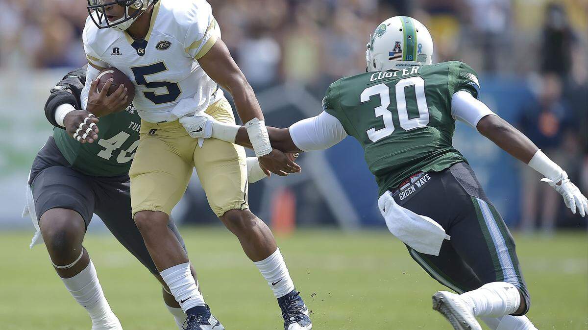MIKE STEWART/Associated PressGeorgia Tech quarterback Justin Thomas runs against Tulane safety Tristan Cooper during the first half Sept. 12 in Atlanta.