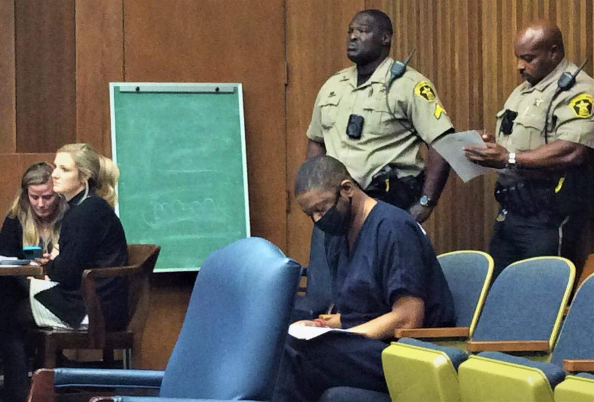 Marcus King signs court paperwork before pleading guilty to murder for stabbing wife De Ann King repeatedly as her sister tried to defend her.