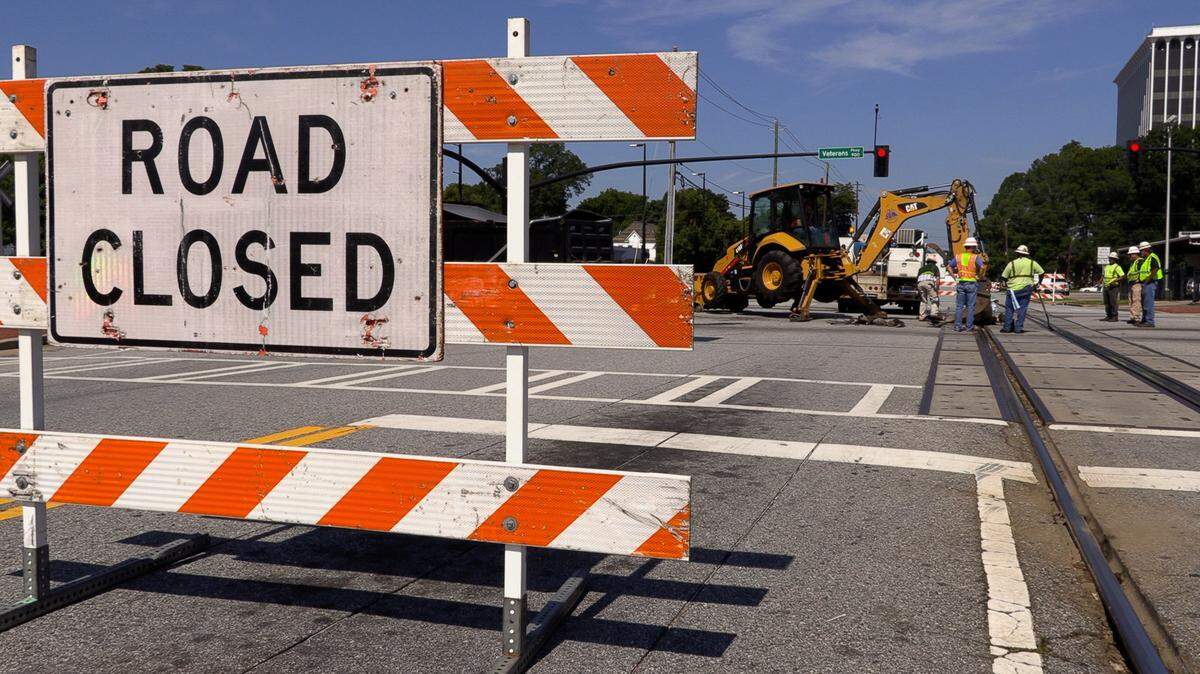 Workers make repairs Monday morning to the railroad crossing at the intersection of Veterans Parkway and Ninth Street in Columbus. The work caused the closure of a section of Veterans Parkway and the re-routing of traffic to adjacent streets.
