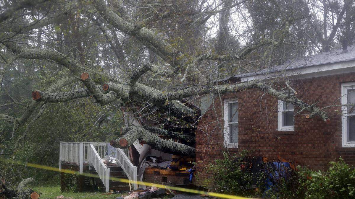 A fallen tree is shown after it crashed through the home where a woman and her baby were killed in Wilmington, N.C., after Hurricane Florence made landfall Sept. 14.