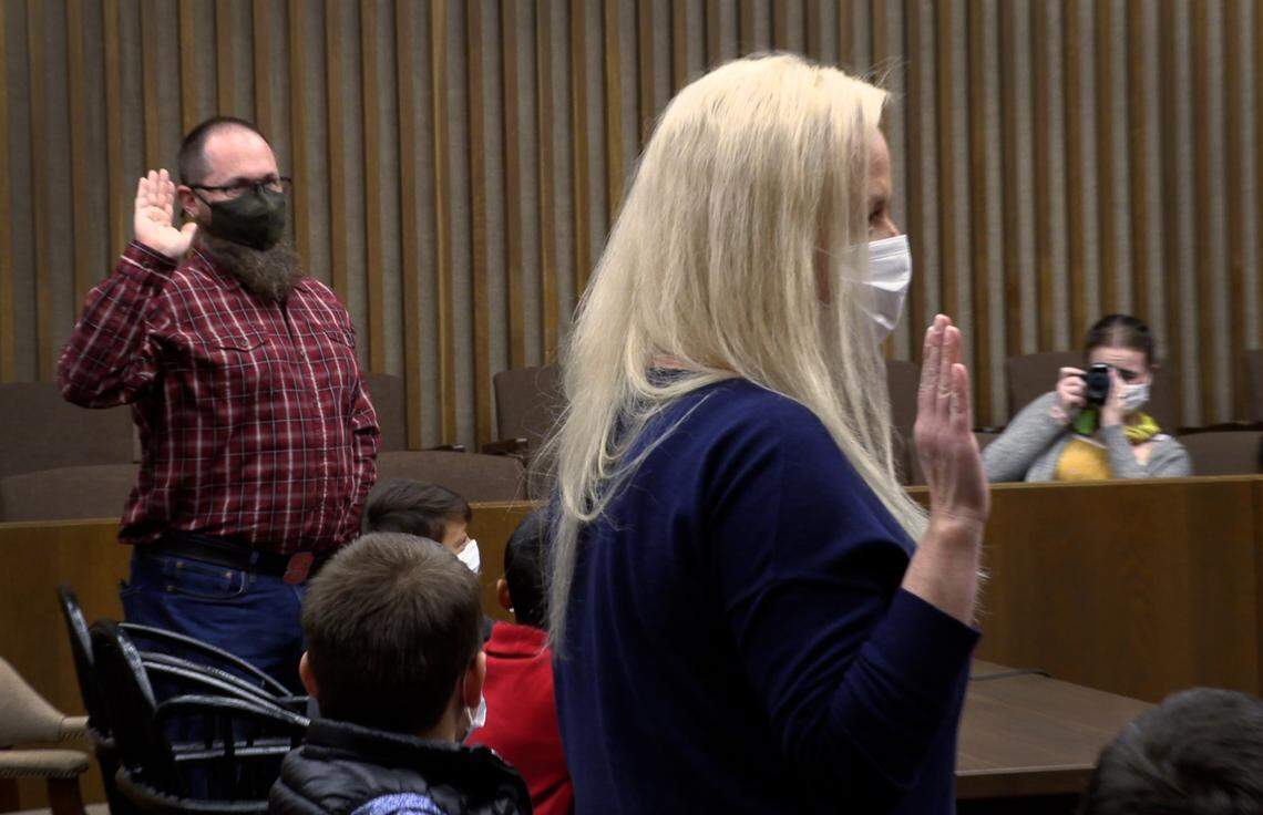 Angela and Elliott Turbeville are sworn in Monday afternoon in Superior Court Judge Maureen Gottfried’s courtroom during a hearing to finalize the Turbevilles’ adoption of six children, all siblings.