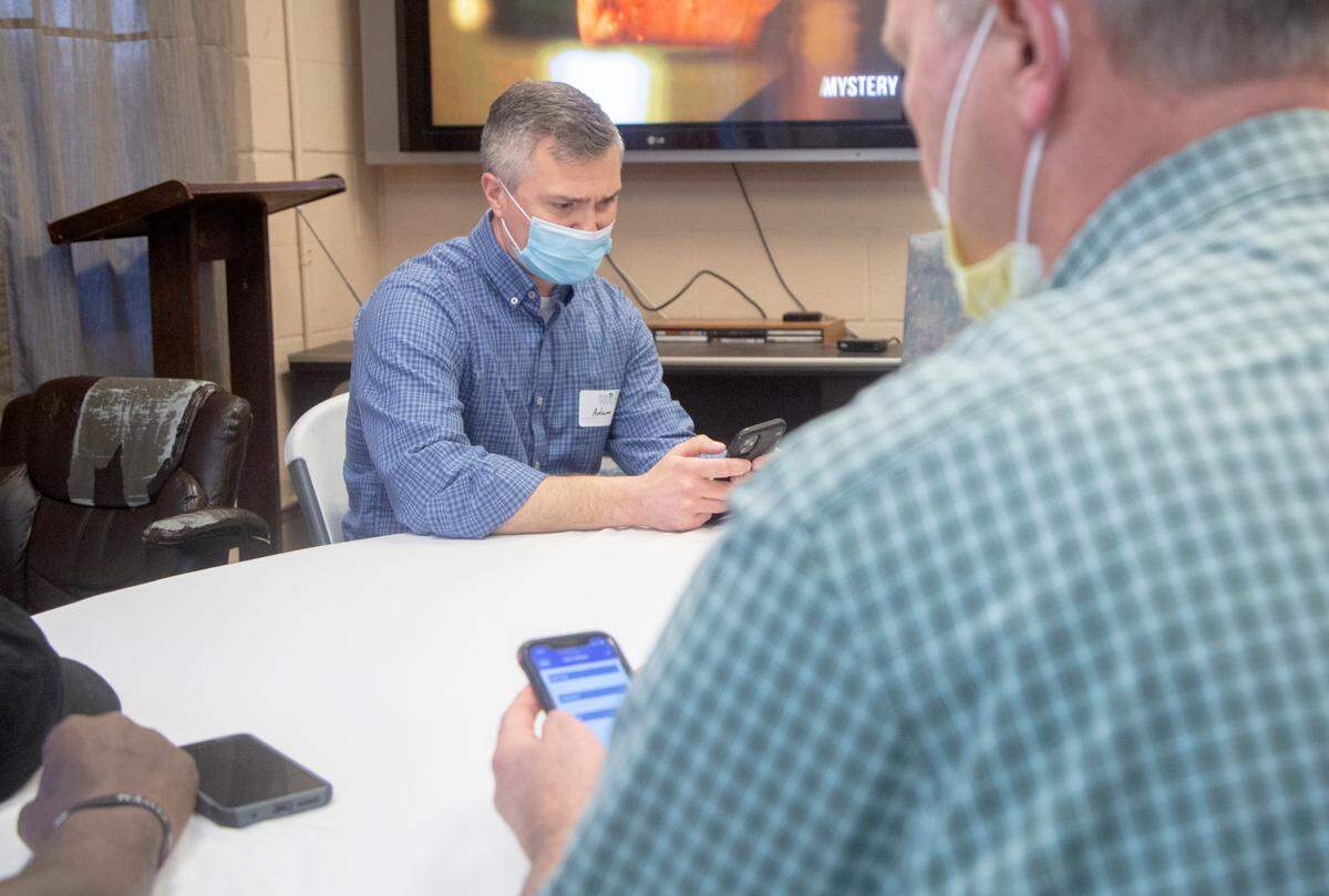 Volunteer Adam Coursey conducts a Point in Time Count survey with a client living at Grace House, a transitional living facility for men in Columbus, Ga. on Feb. 22, 2022. Home for Good executes an annual count of those experiencing homelessness in Muscogee and Russell County.