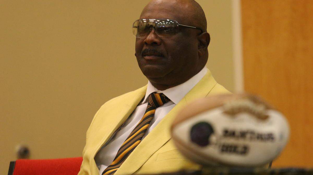 Former Mt. Olive High star Oliver Davis awaits his turn to speak during a ceremony on Thursday at Mt. Olive Intermediate School. Davis presented the school with a golden football to commemorate the Super Bowl's 50th anniversary. Davis played for the Cleveland Browns and Cincinnati Bengals, the latter of which lost to the San Francisco 49ers in Super Bowl XVI. (DAVID MITCHELL/dmitchell@ledger-enquirer.com)
