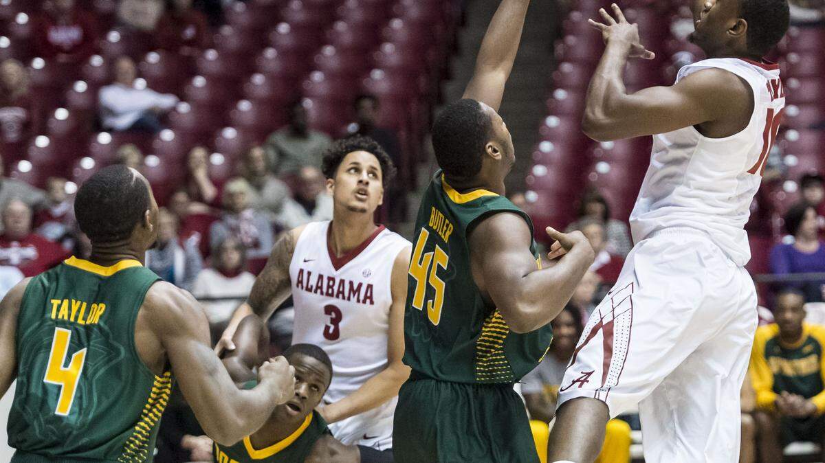 Alabama forward Jimmie Taylor (10) shoots over Norfolk State forward Jordan Butler (45) during an NCAA college basketball game, Saturday, Jan. 2, 2016, in Tuscaloosa, Ala. (Vasha Hunt /AL.com via AP) MAGS OUT; MANDATORY CREDIT