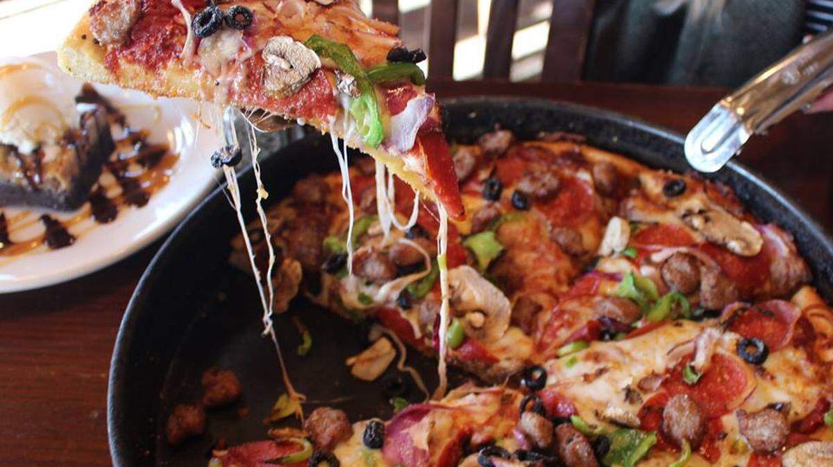 Old Chicago Pizza & Taproom is offering free pizza for a year to the first 100 people in line at its upcoming grand opening. -- Image from  Old Chicago Pizza on Facebook