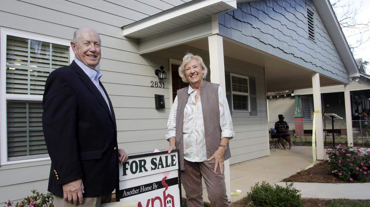 ROBIN TRIMARCHI/rtrimarchi@ledger-enquirer.comDon McCollum, left, and Suzanne Supple stand in front of a newly built home on 10th Street in Columbus following a ribbon-cutting ceremony Wednesday. It is the 11th house built as part of the Wynnton Neighborhood Housing program since 2008. The group has also rehabilitated several houses, and it has worked on the homes of elderly residents who cannot afford repairs. McCollum and Supple are two founders of the program, which began after a group of volunteers worked in New Orleans following Hurricane Katrina.