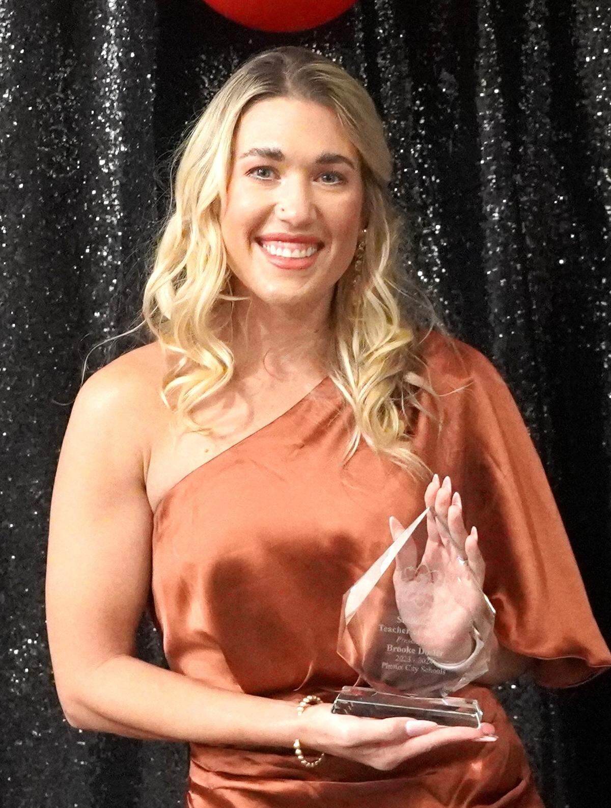 Brooke Dosier, an eighth-grade math teacher at South Girard School, is the Phenix City Schools Secondary Teacher of the Year. She poses with her award at the PCS Night of Stars gala Dec. 7, 2023.