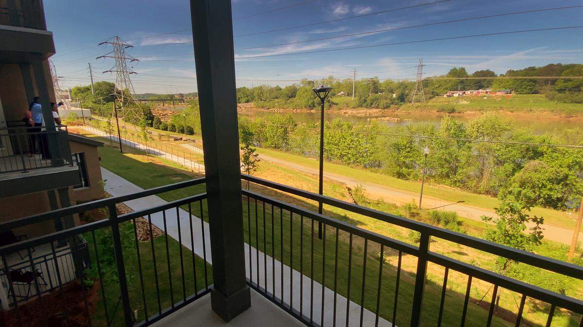 Balconies for some apartments at The Banks at Mill Village overlook the Columbus Riverwalk and the Chattahoochee River. The Housing Authority of Columbus, Georgia, Columbia Residential, and MercyMed of Columbus hosted a ribbon-cutting ceremony and celebration Tuesday morning for The Banks at Mill Village, a new 102-unit mixed-income housing development in Columbus, Georgia. 04/18/2023