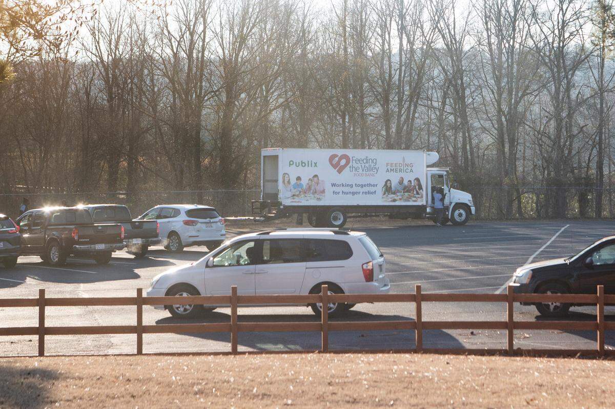 Dozens of cars line up at a Feeding the Valley mobile food pantry site in Hamilton, Ga. on Jan. 27, 2022.