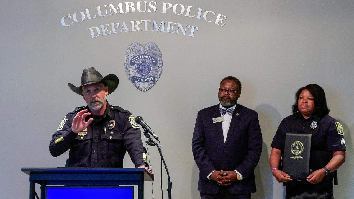Lance Deaton, assistant chief of operations for the Columbus Police Department, left, speaks during an April 7, 2026, new conference, where Georgia state Rep. Teddy Reese (D-Columbus), center, and other legislators presented a resolution congratulating Columbus Police Chief Stoney Mathis and CPD for being named the Georgia Chapter of the FBI National Academy Associates’ Phyllis Goodwin Agency of the Year. Reese also presented a resolution to Columbus Police Sgt. Katina Williams, right, honoring her for being selected as WRBL’s 2026 Remarkable Woman.