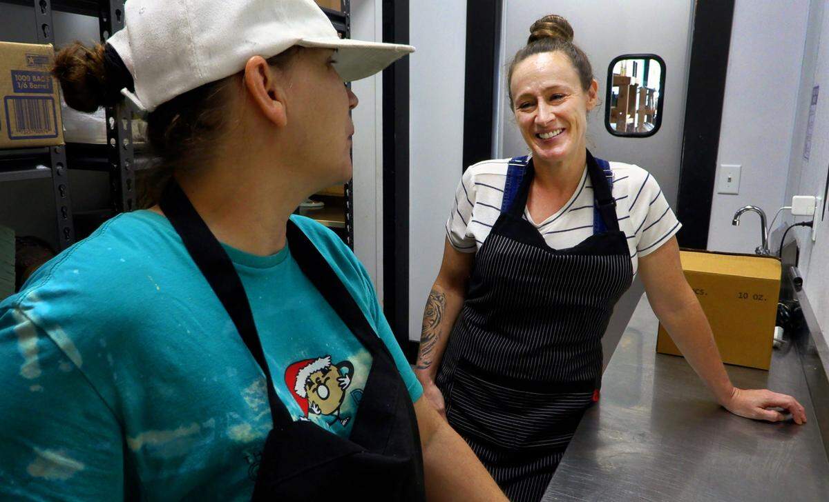 Brittney Espersen,right, the general manager/chef at The Food Mill in Columbus, Georgia, talks with Wendy Smith, an intern at The Food Mill from the Truth Spring Trade School.