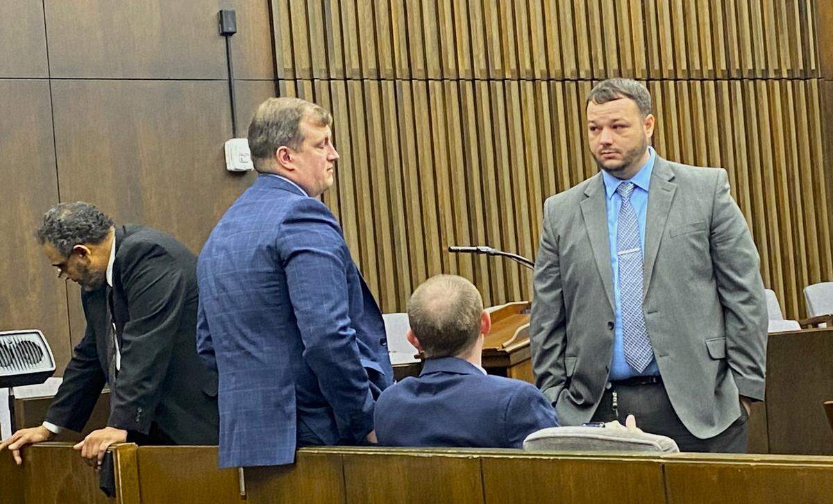 Left to right, lead prosecutor Ray Daniel speaks with the victim’s family as Assistant District Attorney Austin Hammock, DA investigator Jeff Carter and Detective Kyle Tuggle confer.