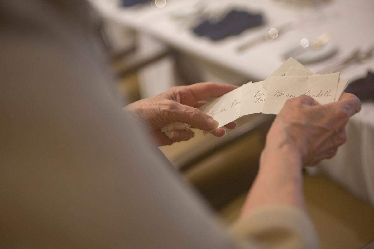 Lucile Lambert puts out place cards before a luncheon to celebrate her birthday and scrapbooks on June 9, 2021, at Spring Harbor at Green Island in Columbus, Ga. The three scrapbooks were presented to Columbus State University to live in their archive.