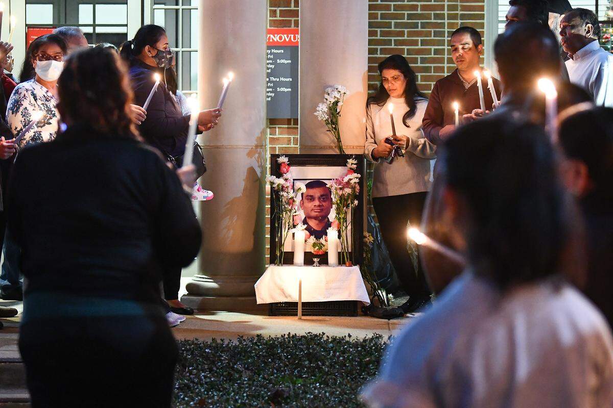 Family and friends gather Dec. 13, 2021, for a candlelight vigil for Amit Kumar Patel outside of the Synovus branch at 4505 Buena Vista Road where he was shot to death.