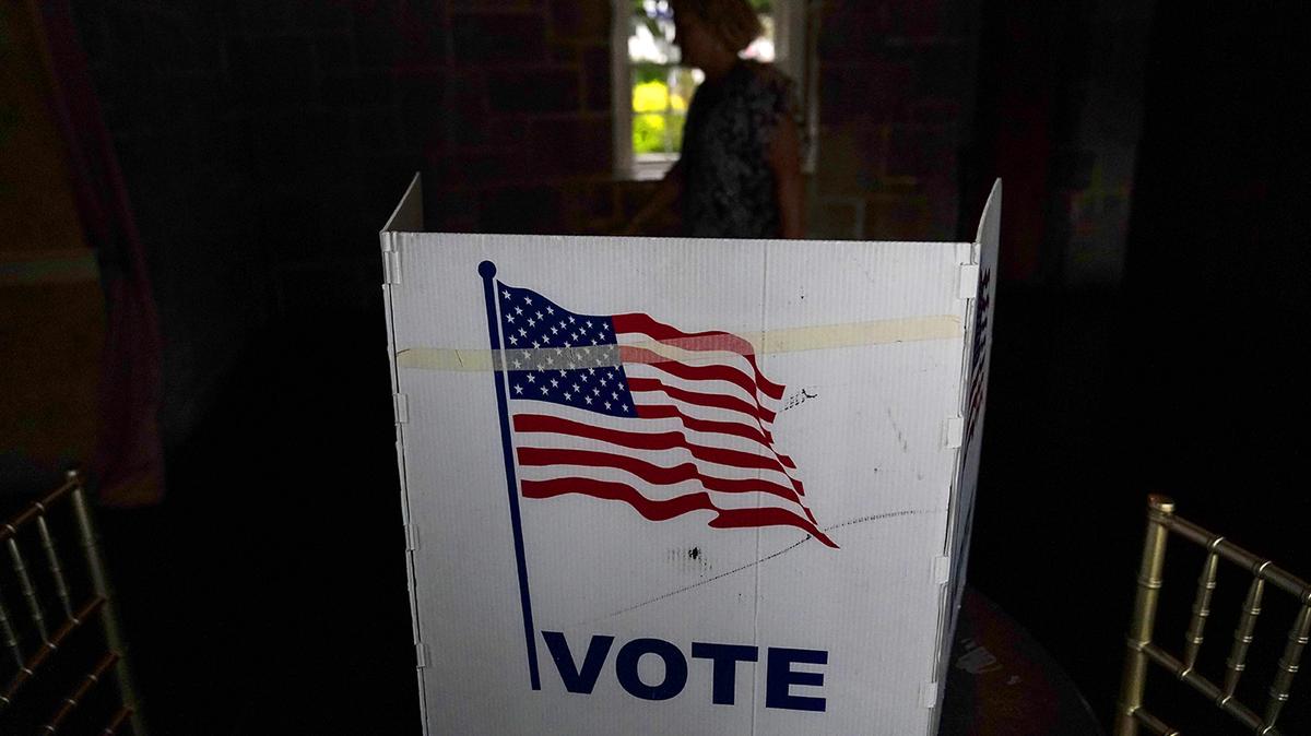 A person waits in line to vote in the Georgia’s primary election on May 24, 2022, in Atlanta.