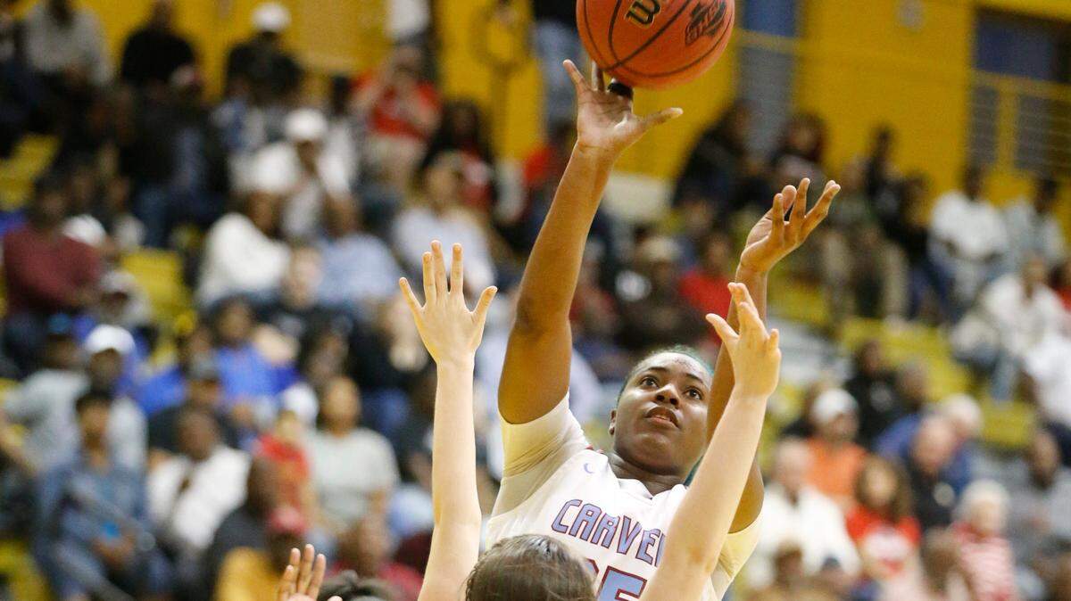 Carver senior forward Jailyn Shaw shoots over a defender at the end of the first half during Saturday’s semifinal in the Georgia High School Association Class AAAA girls basketball state tournament. 03/02/2019