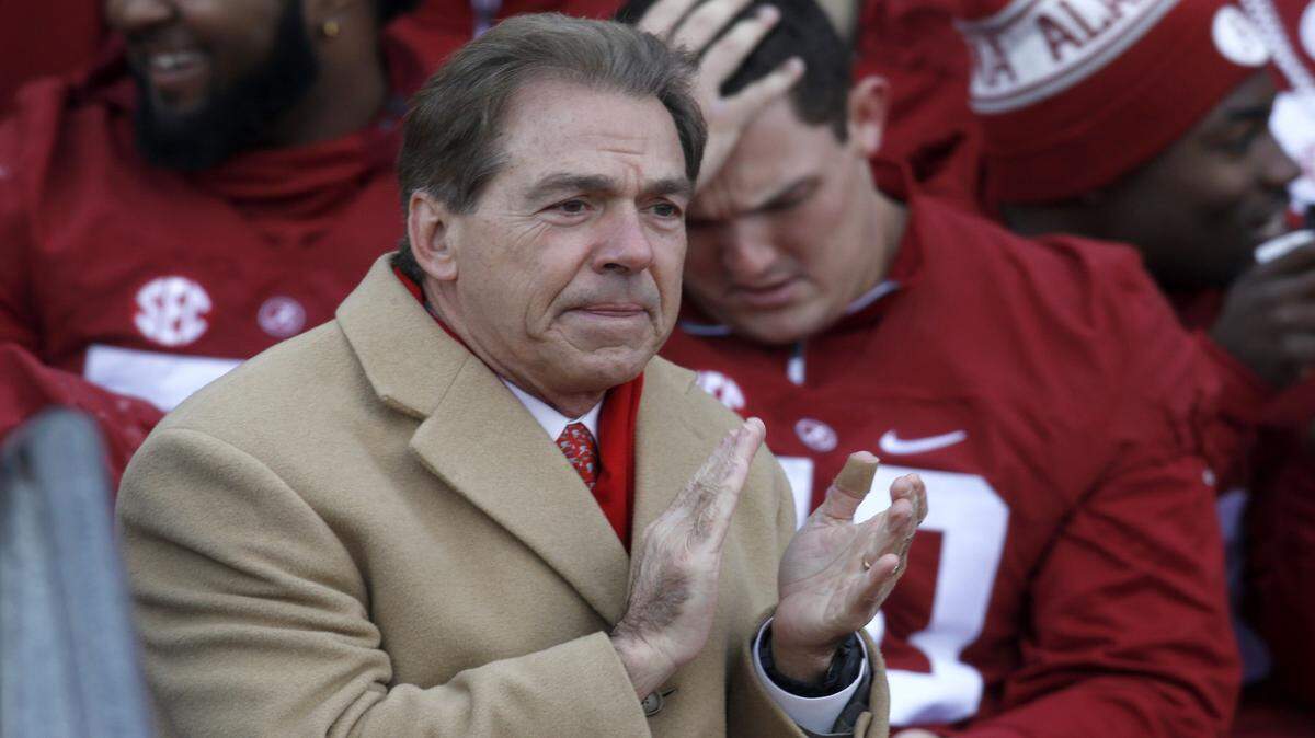 Alabama head coach Nick Saban applauds as his team's accomplishments are named, Saturday, Jan. 23, 2016, in Tuscaloosa, Ala. Alabama football fans turned out by the thousands to celebrate the Crimson Tide's fourth national championship in seven years. (AP Photo/Hal Yeager)