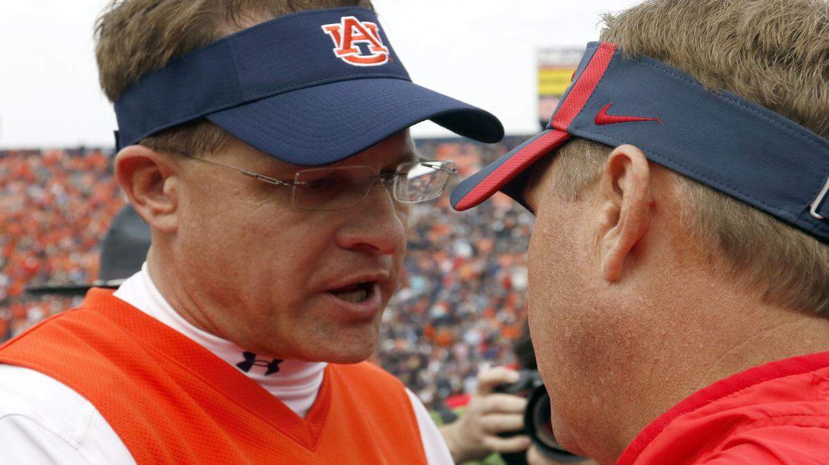 Auburn head coach Gus Malzahn talks with Mississippi head coach Hugh Freeze after Mississippi defeated Auburn 27-19 in an NCAA college football game, Saturday, Oct. 31, 2015, in Auburn, Ala. (AP Photo/Butch Dill)