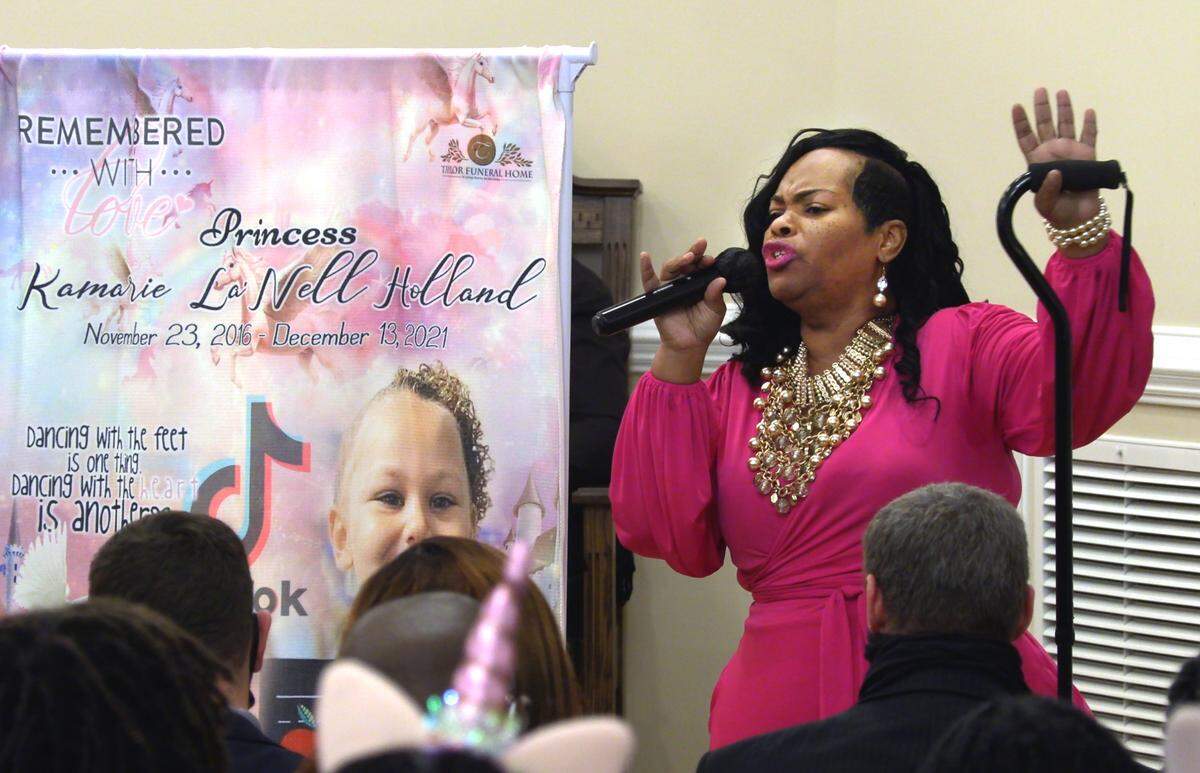 Mia Chadwick sings at the funeral service for Kamarie Holland, 5, Wednesday in Phenix City, Alabama.
