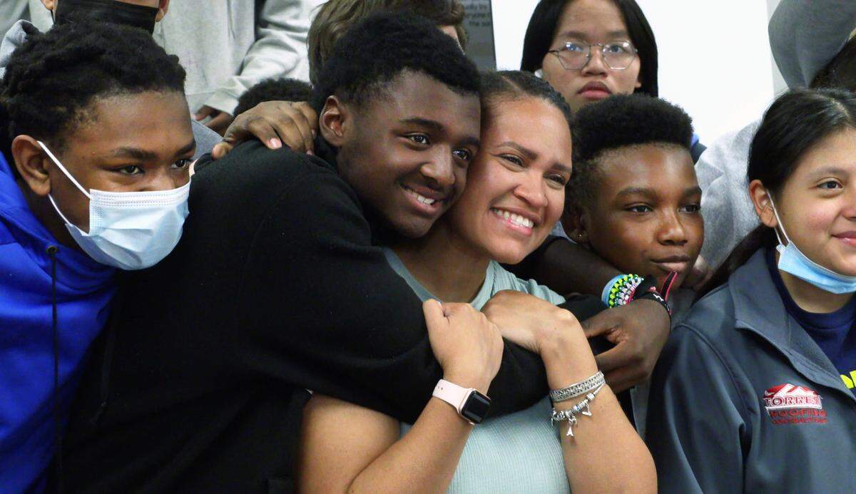 Vanessa Ellis, a teacher at Veterans Memorial Middle School, poses for a photo with her students after learning she is a Muscogee County School District 2022 Teacher of the Year finalist. 03/29/2022