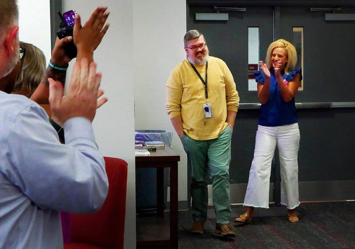 Charles Repass, center, a special education teacher at Jordan Vocational High School, is applauded after learning the news Tuesday morning that he has been selected as one of three finalists for the Muscogee County School District 2025 Teacher of the Year award. 04/08/2025