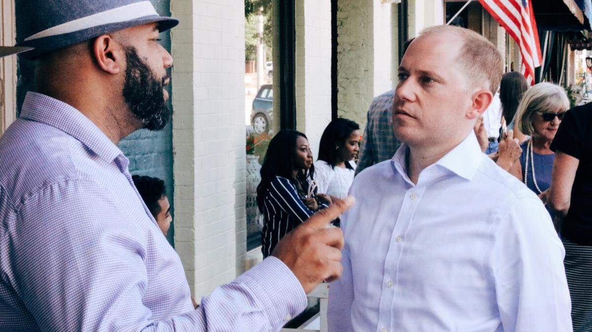 Democratic attorney general candidate Charlie Bailey, right, listens to Curtis Brown of Troup County recently while campaigning in Pine Mountain.