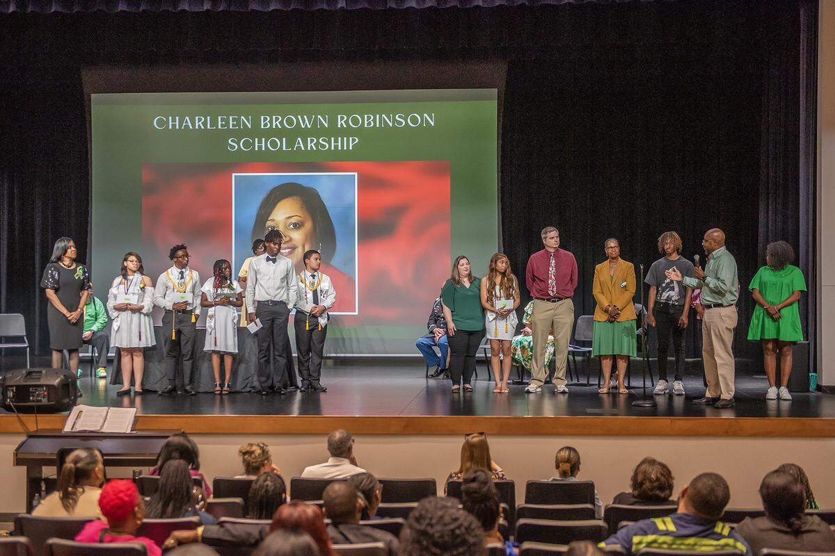 Retired Spencer High School principal Johnny Freeman speaks about the Charleen Brown Robinson Scholarship and the Alexis McRae Scholarship he established and funded for six recipients during the senior class awards ceremony May 8, 2024, in the Spencer auditorium.