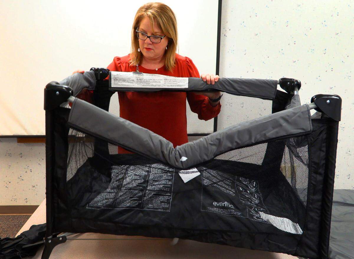 Pam Fair, director of Safe Kids Columbus, assembles a portable play yard and bassinet prior to demonstrating the ABCs of Safe Sleep. To further emphasize safe sleep practices, the nonprofit Safe Kids Columbus is hosting “Safe Sleep Classes” at 4 p.m. Oct. 15, Nov. 12 and Dec. 17 at 615 19th St., across from the John B. Amos Cancer Center. Each hour-long class is free, said Pam Fair of Safe Kids Columbus. Anyone interested may call 706-321-6720. The program is intended for women who are in or close to their third trimester of pregnancy. Each participant who qualifies for Medicaid can get a free portable play pen with a bassinet, commonly called a “Pack N Play,” which is safe for putting a baby to bed in the mother’s room. Fair said the priority will be providing those to parents who don’t already have one.