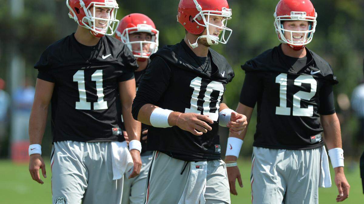 BEAU CABELL/THE TELEGRAPH 
 Athens, Ga., 08/04/2015: Georgia quarterbacks Greyson Lambert, Faton Bauta, and Brice Ramsey make their way through practice stations at the Bulldogs first practice of the season Tuesday afternoon.