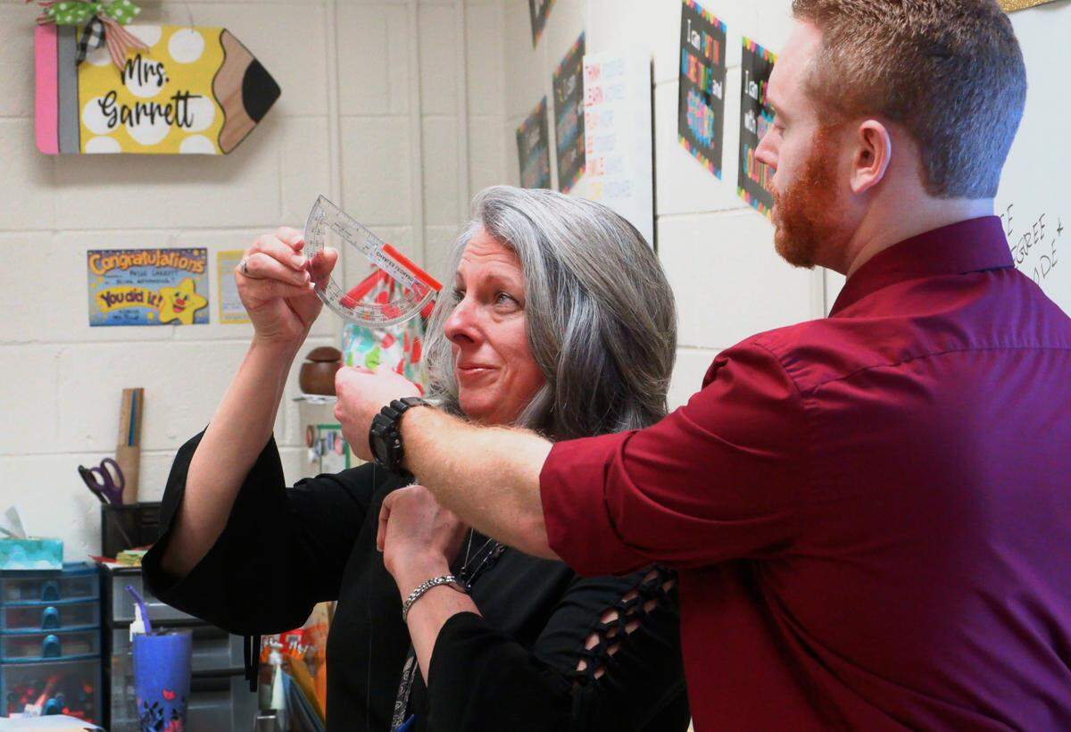 Paige Garrett, left, a learning support specialist teacher at Hardaway High School, teaches a geometry class alongside fellow Hardaway teacher Joshua Alsup.