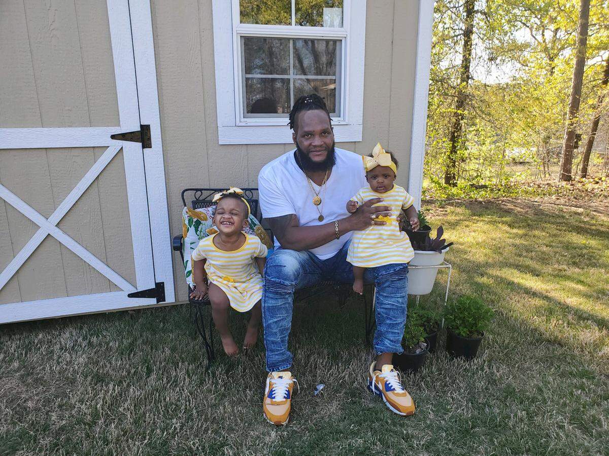 Jerome Lawson, the owner of Twist Skillit food truck, with his two daughters.