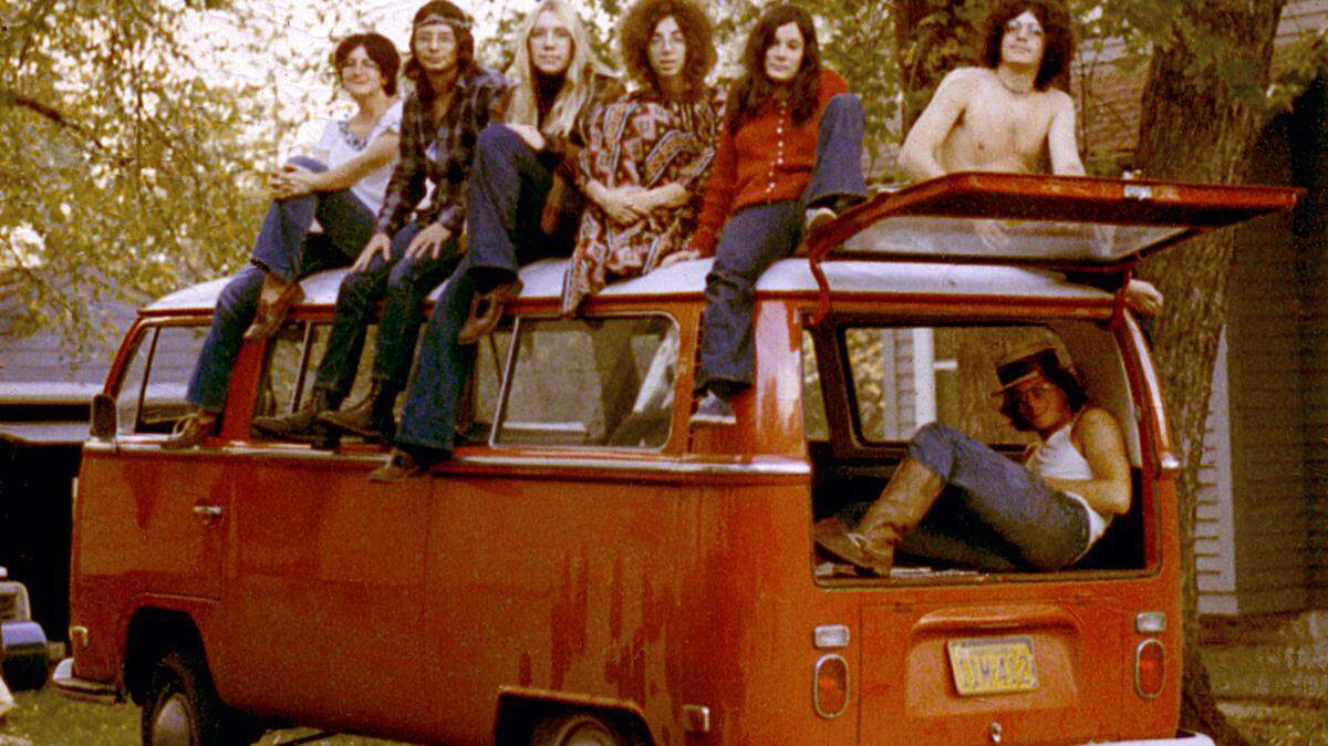 This photo is on permanent display in the May 4 Visitors Center at Kent State University, as an example of the counterculture students of that era. The center tells the story of the May 4, 1970, clash between protesters and Ohio National Guard troops, who shot 13 unarmed students, killing four of them, during the demonstration against the United States’ expansion of the Vietnam War into Cambodia. The photo’s caption in the exhibit says, “Residents of Costley Court in Kent, Ohio, come together in their own counterculture community.” Now-retired Columbus architect Ken Levy, reclining in the back of the bus, shot the photo with a 10-second delay, placing his camera on a garbage can.