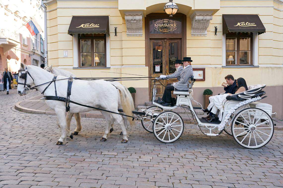 Zach and Charity take a romantic horse-drawn carriage rise down the streets of Estonia.