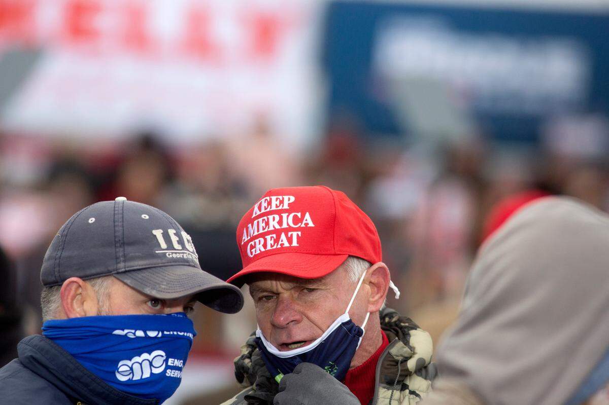A majority of rally attendants wore masks as they gathered to hear Vice President Mike Pence speak on Thursday, Dec. 17, 2020 at the Columbus Airport. Pence rallied for Republican Senators David Perdue and Kelly Loeffler before the Senate run-off on January 5, 2021 against Democratic candidates Raphael Warnock and Jon Ossoff.