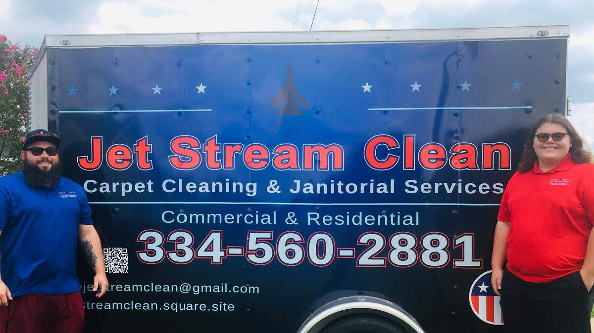 Nickolas Folmar, left, stands next to a trailer for his business, Jet Stream Clean. Folmar founded the company in September 2020.