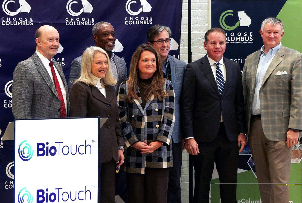 Participants in a Dec. 4, 2025, news conference at the Choose Columbus office gather for a group photo after it was announced that BioTouch, a health care logistics company based in West Haven, Connecticut, will invest $12.5 million to expand its two facilities in Columbus.