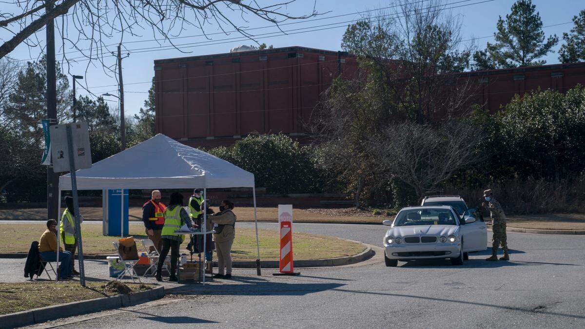 National Guard troops direct those with appointments towards the vaccination megasite at the Civic Center in Columbus, Ga., on Saturday, Jan. 23, 2021.